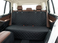 Dog car seat cover fully installed across SUV back bench seat showing headrest straps and seat belt openings